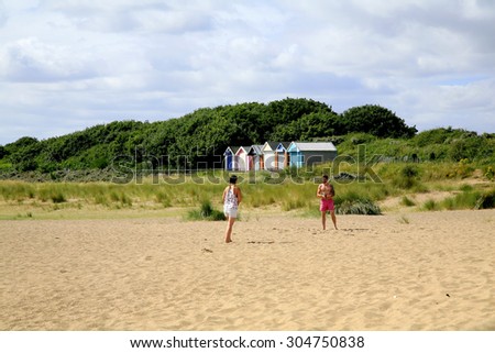 CHAPEL ST. LEONARDS, LINCOLNSHIRE, UK AUGUST 04, 2015.  A young couple play on the sand at Chapel Point near Chapel St. Leonards in Lincolnshire, UK.