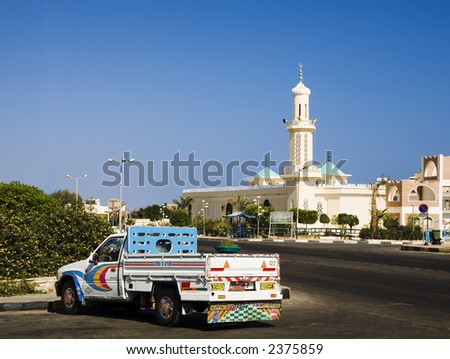 mosque with one minaret in Hurgada, Egypt with The traditional local painted lorry