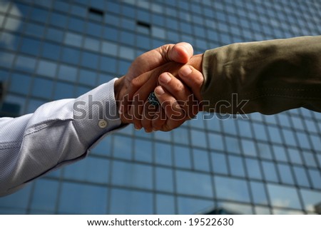 man and woman business team shaking hands