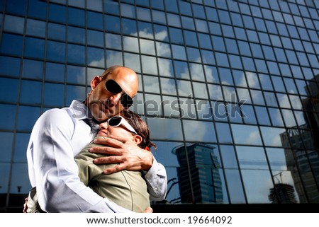 Portrait of a businessman and woman who lost money in stocks over office building