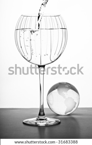 large  red wine crystal glass with globe with water pouring