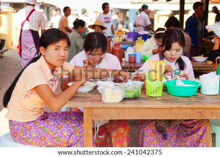 Heho, Myanmar - March 02, 2011 : Young Burmese women having lunch at five-day market. Five-day market is open once in every five days and is very busy