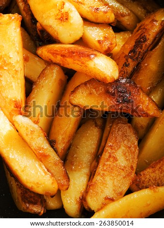 Fried potatos with sugar burn into caramel, close up
