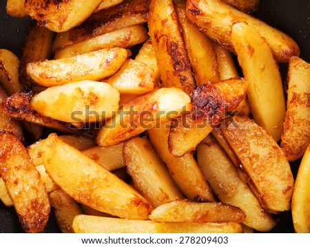 Fried potatos with sugar burn into caramel, close up
