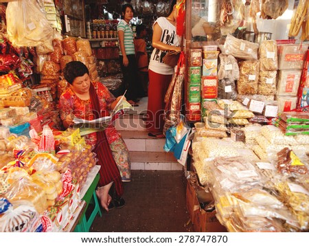 Yangon, Myanmar - February 24, 2011 : Senior Burmese woman selling seasonings and condiments in the street market.