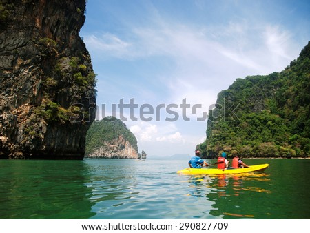 Pang Nga, Thailand - March 16, 2011 : Couple of tourists kayaking in the hongs of Pang Nga Bay in the morning.