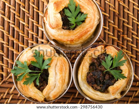 Puff pastry stuffed with ground beef, onion, cumin and other seasonings, shot from above