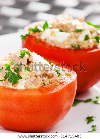 Stuffed tomatos with tuna fish. Cropped view, vertical shot