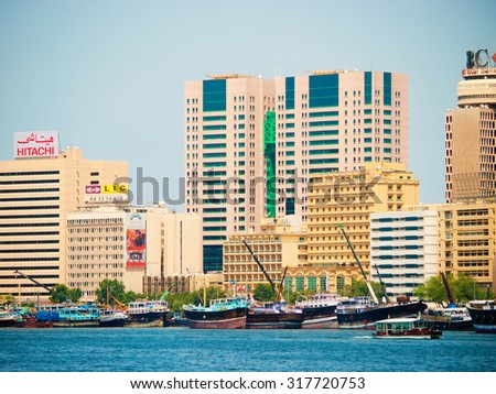 Dubai, United Arab Emirates - March 24, 2011 : Morning view of Dubai creek district. In the background there are several of the large banks and in the water one can see abras - the water taxis