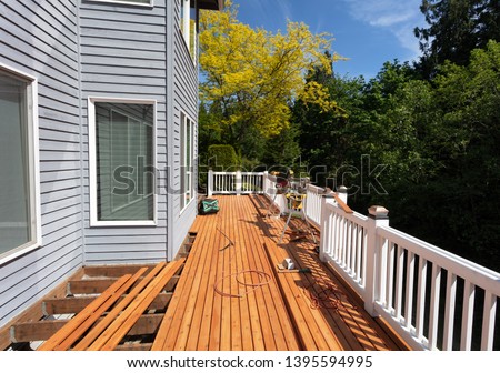 Outdoor wooden deck being remodeled with new red cedar wood floor boards being installed     Photo stock © 