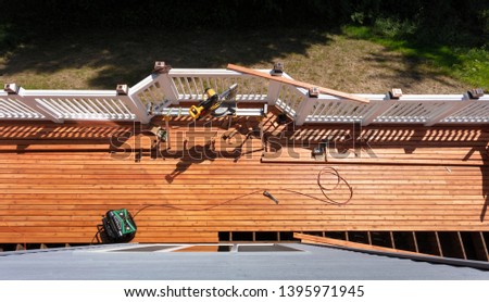 Overhead view of outdoor wooden deck being remodeled with power and hand tools on floor boards Photo stock © 