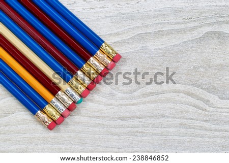 Pencil erasers lined up on rustic white wood