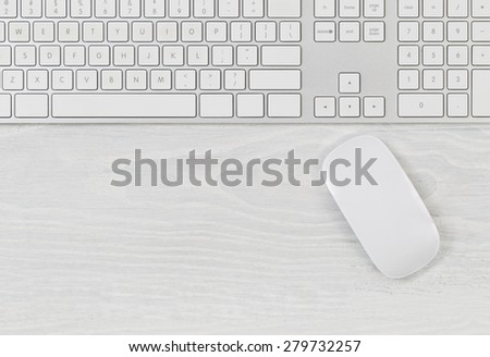 White office table with computer keyboard and mouse. Top view with plenty of copy space.