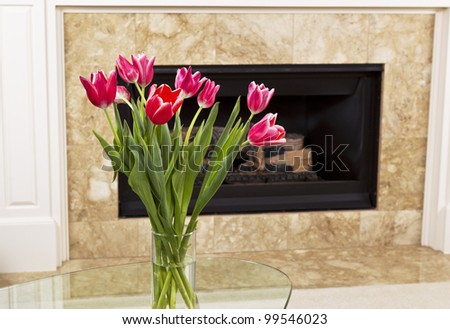 Seasonal flowers on table in front of fire place