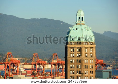 Vancouver Historic Beaux-Arts style Sun Tower and North Vancouver city skyline across Vancouver Harbour, Vancouver, British Columbia, Canada.