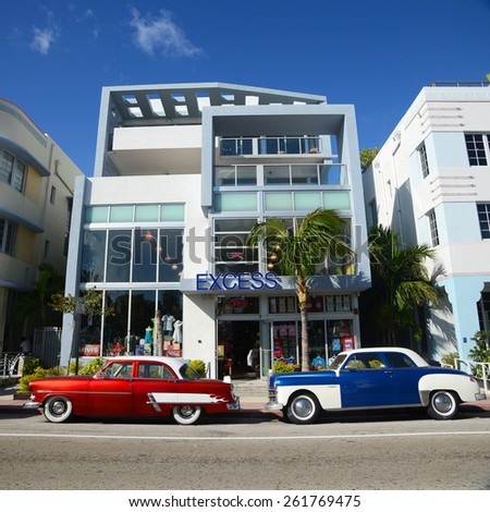 MIAMI - DEC 24: Excess Building with Art Deco Style and colorful antique cars in Miami Beach on December 24th, 2012 in Miami, Florida, USA.
