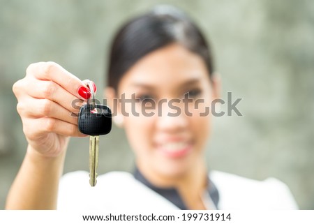 Pretty girl with car key in her hand