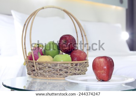 Apples and group of fruit present for breakfast in the bedroom.