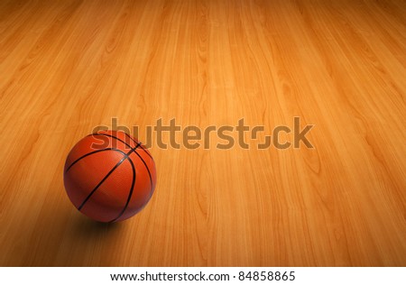 A basketball on the wooden floor as background