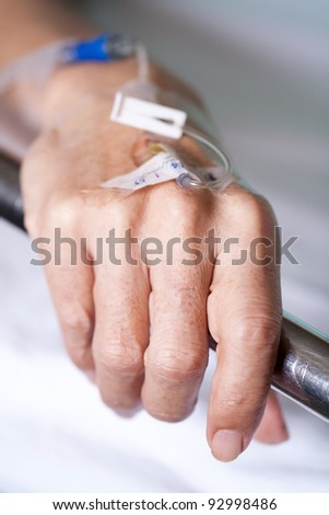 close up of a iv drip in patient\'s hand. Hand of my best friend, I promised to make donation for him every year.