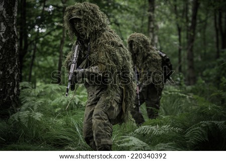 Little green men during patrol in forest