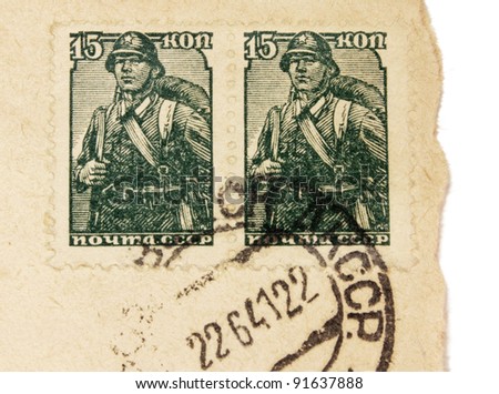 RUSSIA - CIRCA 1941. Two vintage stamps printed in USSR shows image of Russian soldier. Vintage postmark from Soviet Union on an old  envelope (dated 22.06.1941 - first day of the war in Russia). circa 1941
