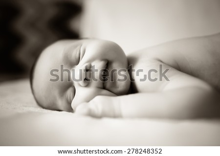 beautiful sweet newborn baby sleeping on a blanket. Black and white photo