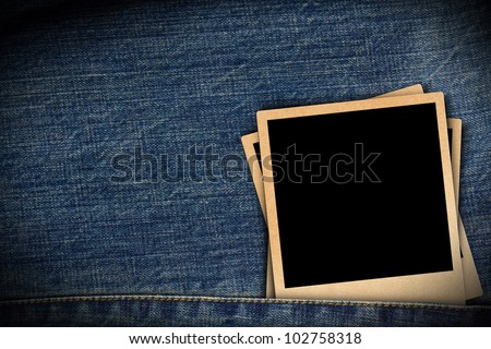 Blank instant photo frames on blue jeans background