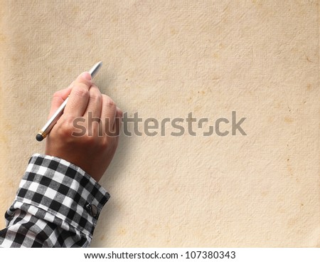 Pen in hand on paper background