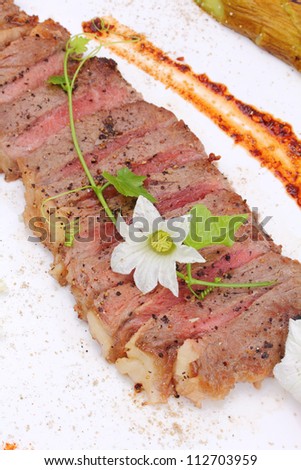 Beefsteak decorate with edible flowers, (Thai food Style) Macro closeup for design work