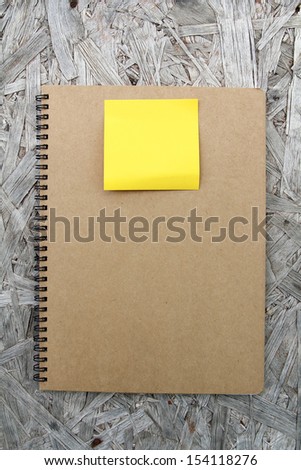 Recycled paper notebook front cover on wood background
