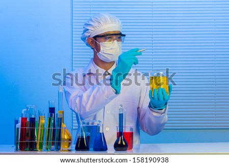 Man scientist holding a test tube with liquid, With holding pen drawing for design work