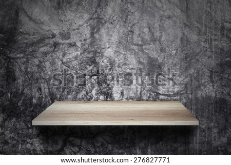 Empty wood shelf on cement wall