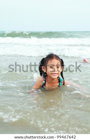 Happy asia little girl swimming at sea