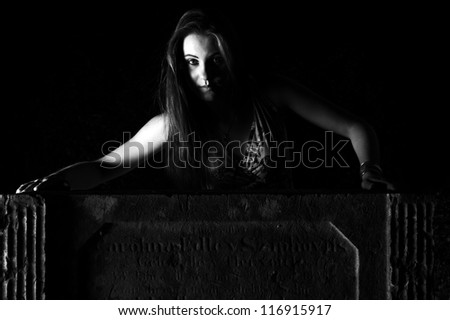 Woman by the grave - Halloween Concept - dramatic lighting