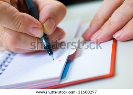 A close up of a hand of the businessman with the pen. Shallow depth of field