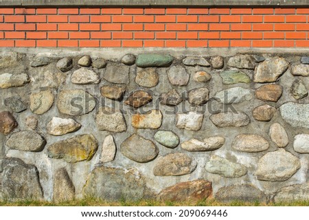 Big isolated natural fence around a house made of stone and brick