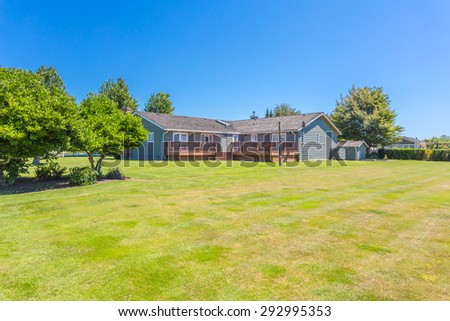 Custom built luxury farm house with nicely trimmed and designed front yard, lawn in a residential neighborhood in Canada. Large family house.
