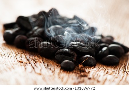 Freshly roasted coffee beans on a wooden  table