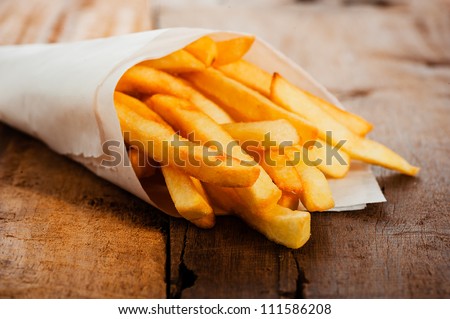 Similar – Image, Stock Photo Bag fries and fry potatoes on the table