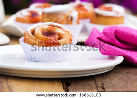 small cake with strawberry jam on white plate