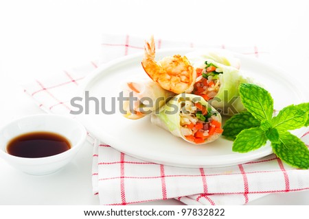 Vegetarian spring roll with carrot, soy sprouts and shrimp on white background as a studio shot