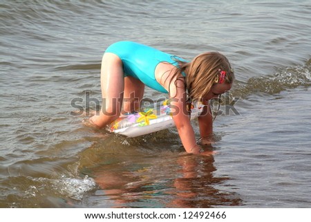 Girl learning to swim in the sea