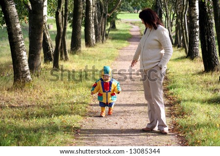 Mother and daughter walking in the avenue