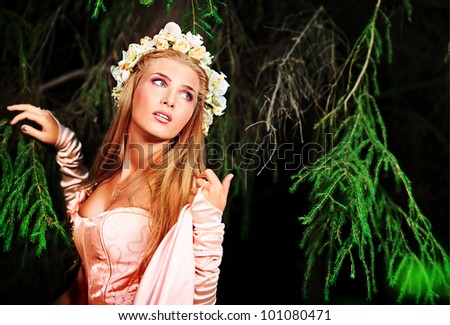 Portrait of a dreamy fairy girl in a forest.