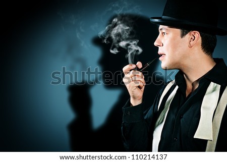 Portrait of a retro detective in pot hat smoking his pipe.
