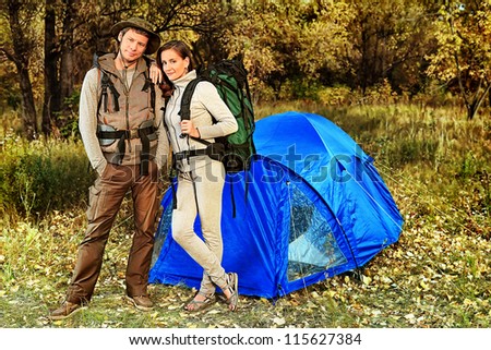 Happy couple having a rest outdoor in tent.