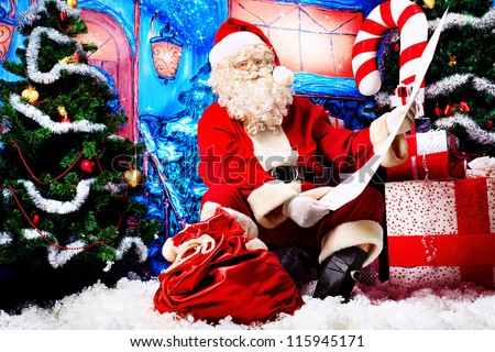 Santa Claus posing with a list of presents over Christmas background.