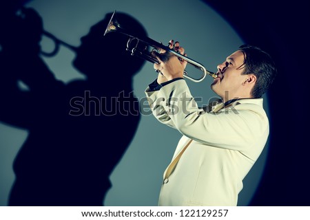 Portrait of a musician playing the trumpet at studio.