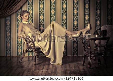 Charming fashionable model posing in the vintage interior.